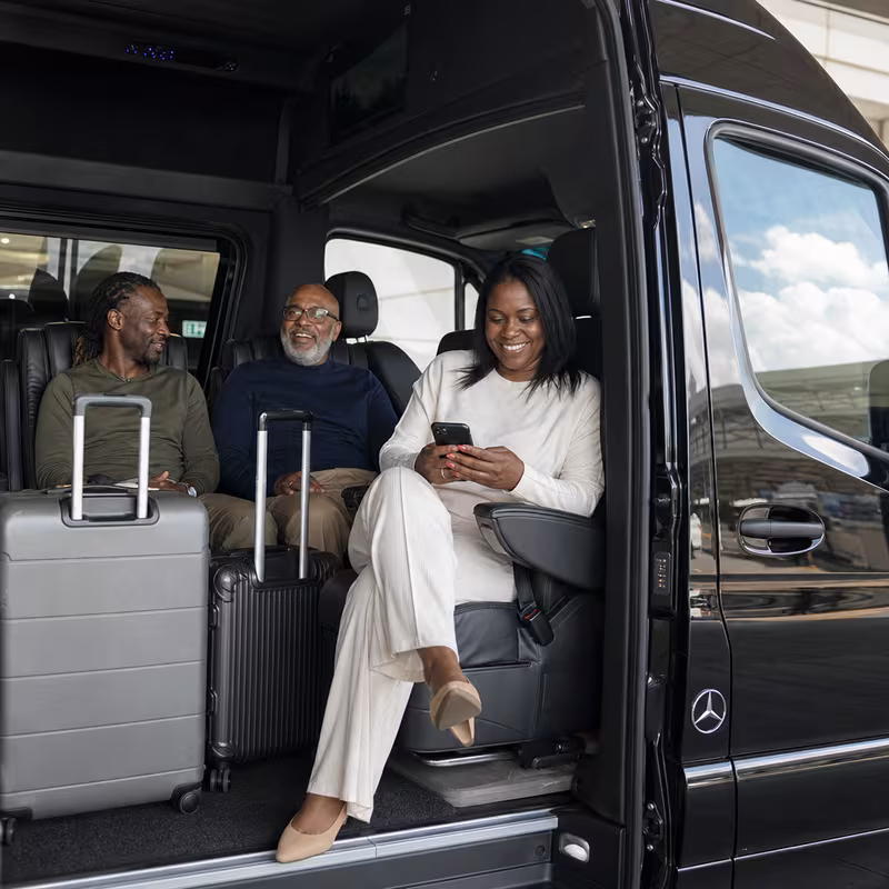 Passengers loading luggage while boarding an St Louis group shuttle