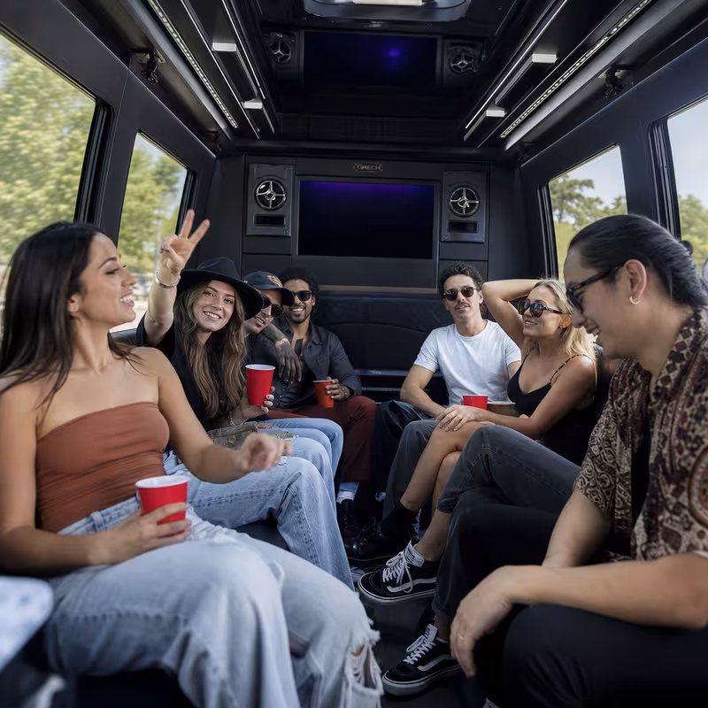 Group boarding a white charter bus for Concert Transportation transportation in St Louis