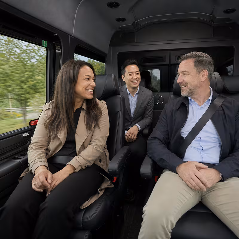 Group boarding a white charter bus for Corporate Transportation transportation in St Louis
