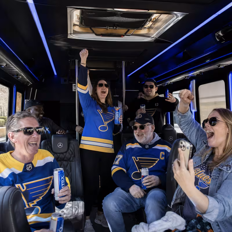 Group boarding a white charter bus for Sporting Event Transportation transportation in St Louis