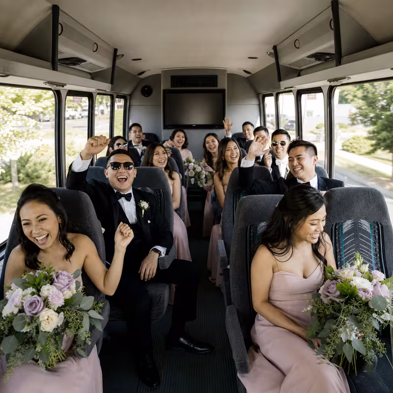 Group boarding a white charter bus for Wedding Transportation transportation in St Louis