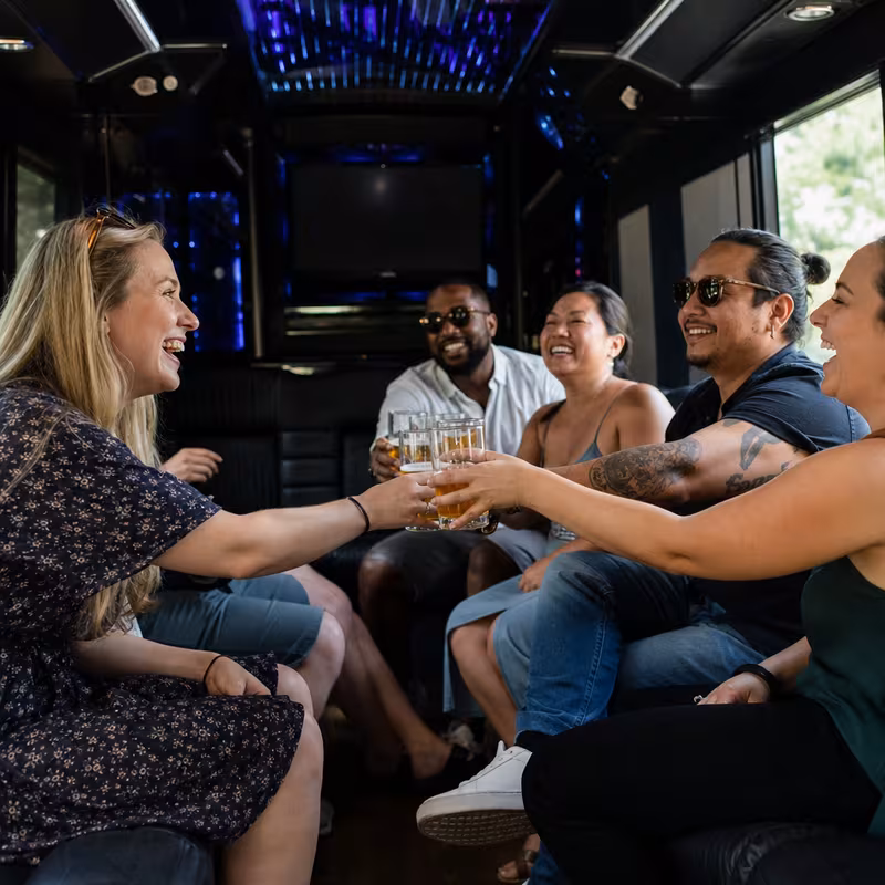 Group boarding a white charter bus for Winery & Brewery Tour Transportation transportation in St Louis