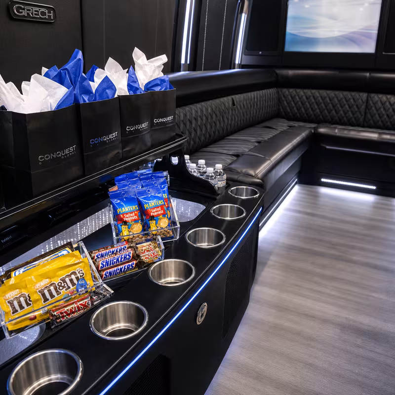 Party bus interior with wraparound leather seating and LED lighting in St Louis